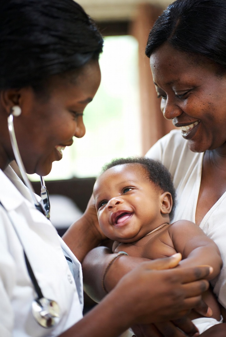 A doctor caring for a mother and her baby at home